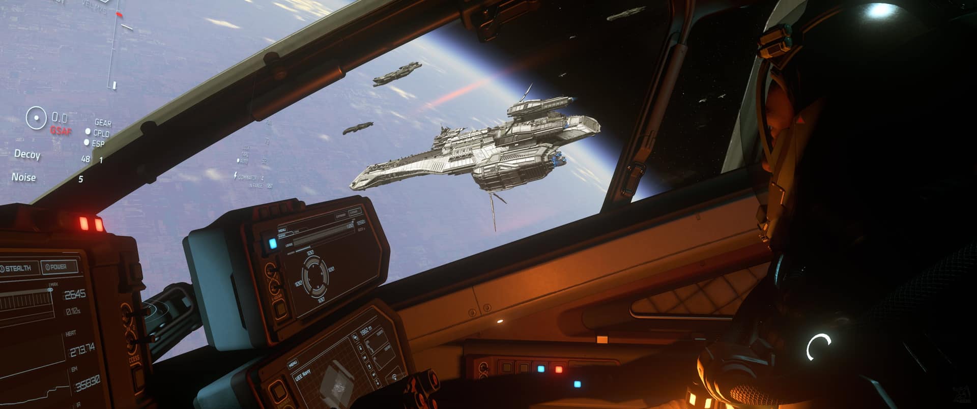A pilot looks out from a fighter cockpit at a UEE Navy capital ship and its escorts cruising above a planet's horizon.