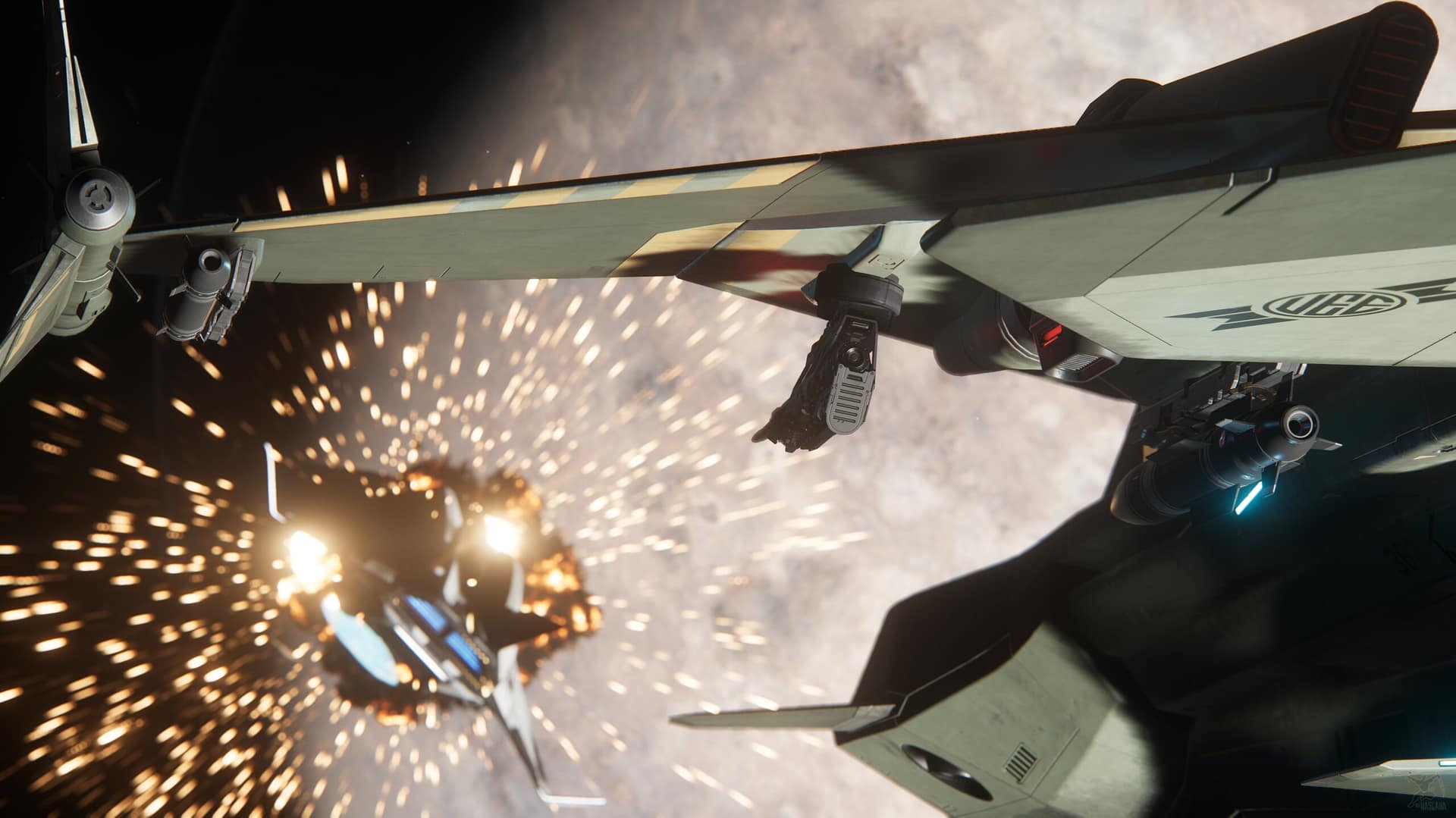 Viewed from beneath a UEE fighter's missile-laden wing, an enemy ship erupts in a burst of sparks and flame against a cratered moon.